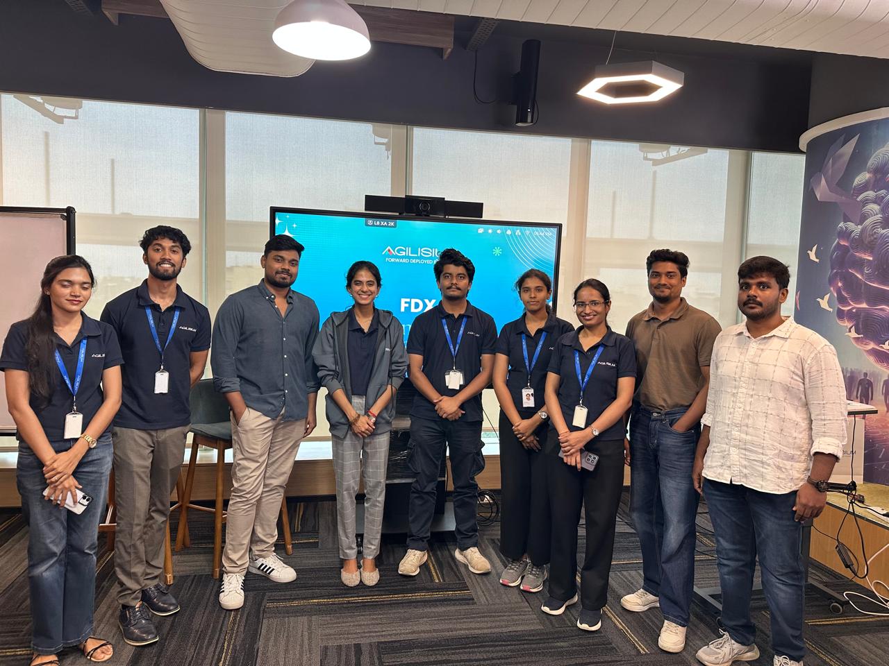 FDXe Sandhai participants standing together in front of the FDX display