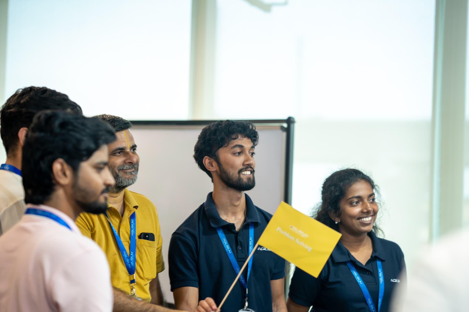 Colleagues holding a Problem Solving flag during FDXe Sandhai